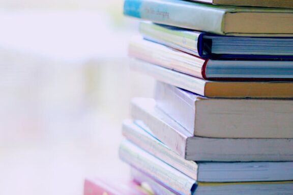 selective focus photo of pile of assorted title books