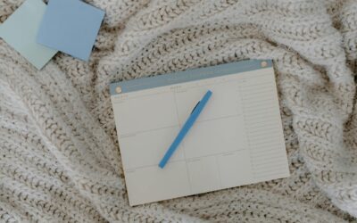 top view of a weekly planner on a knitted blanket